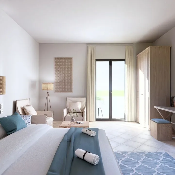 Camera luminosa con letto, zona salotto, scrivania e porta finestra con accesso all'esterno