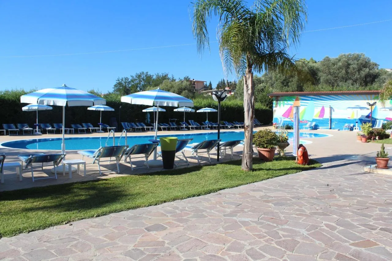 Bordo piscina con lettini, ombrelloni a righe e palma